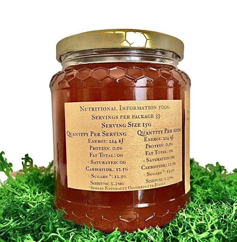 Jar of eirholt honey with a gold label on a grassy background