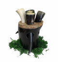 Decorative candle holder with animal horns and tusks on a white background